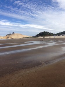 Inn at Cape Kiwanda is nestled between the light colored dune and the darker hill to the right - all ocean view rooms