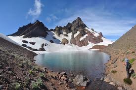 Glacial blue lake hidden among scree and Broken Top peaks